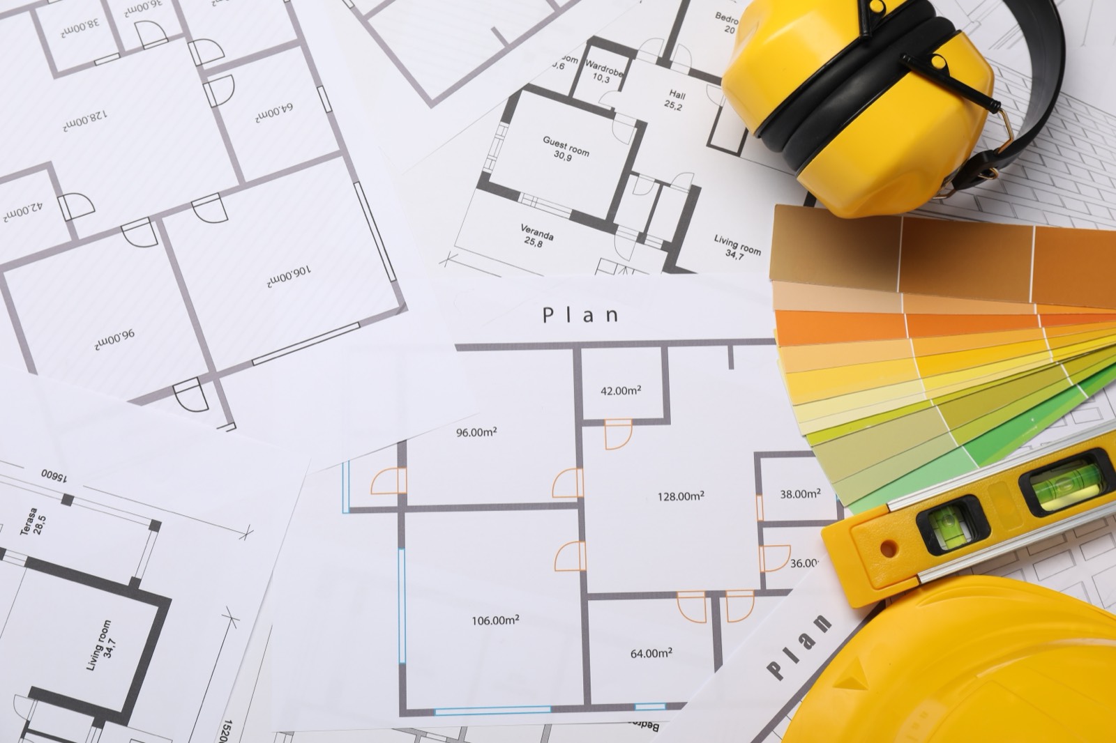 Floor plans with builder's level, hard hat and colour swatches